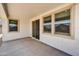 The covered patio has a concrete floor and three windows on the exterior wall at 5875 N 193Rd Dr, Litchfield Park, AZ 85340