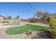 Picturesque backyard offering lush green space and serene desert landscaping at 6615 S 25Th Dr, Phoenix, AZ 85041