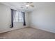 Neutral bedroom features a large window and plush carpeting at 6615 S 25Th Dr, Phoenix, AZ 85041