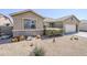Inviting home showcasing xeriscaping, stone accents, and a covered entryway at 6615 S 25Th Dr, Phoenix, AZ 85041