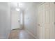 Welcoming entryway features neutral tile flooring, a hanging light fixture, and closet for storing coats at 6615 S 25Th Dr, Phoenix, AZ 85041