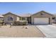 Inviting single-story home featuring a low-maintenance desert landscape and attached two-car garage at 6615 S 25Th Dr, Phoenix, AZ 85041