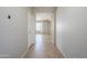 Bright hallway with tile floors that offers a view of the open-concept living area with lots of natural light at 6615 S 25Th Dr, Phoenix, AZ 85041