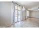Bright living room with neutral walls and tile floors features sliding glass door access to covered patio at 6615 S 25Th Dr, Phoenix, AZ 85041
