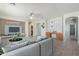 Well-decorated living space featuring modern decor, a built-in media center, and seamless kitchen transition at 6615 S 25Th Dr, Phoenix, AZ 85041