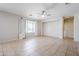 Spacious living room featuring neutral paint, tile flooring, and a ceiling fan at 6615 S 25Th Dr, Phoenix, AZ 85041