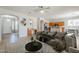 Open-concept living room with a ceiling fan, modern decor, and a seamless transition to the kitchen and dining area at 6615 S 25Th Dr, Phoenix, AZ 85041