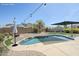 Sparkling pool featuring elegant lounge area, landscaping, and custom pavers at 6615 S 25Th Dr, Phoenix, AZ 85041