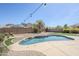Backyard oasis featuring custom pavers, sparkling pool, and elegant seating area at 6615 S 25Th Dr, Phoenix, AZ 85041