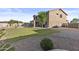 Expansive backyard features a lush lawn, mature trees, and covered patio area, ideal for outdoor activities at 7628 W Donald Dr, Peoria, AZ 85383