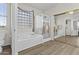 Bright bathroom featuring wood floors, a shower, tub and a large mirror reflecting the space at 7628 W Donald Dr, Peoria, AZ 85383
