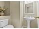 Half bathroom featuring stylish pedestal sink and neutral walls at 7628 W Donald Dr, Peoria, AZ 85383