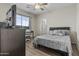 Comfortable bedroom featuring a ceiling fan, desk, and great natural lighting at 7628 W Donald Dr, Peoria, AZ 85383