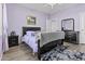 Bedroom featuring wood floors, purple paint and trim, a ceiling fan and a black bedroom set at 7628 W Donald Dr, Peoria, AZ 85383