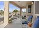 Relaxing covered patio with string lights, comfortable chairs and a serene backyard view at 7628 W Donald Dr, Peoria, AZ 85383