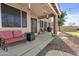 Spacious covered patio featuring comfortable seating, a BBQ grill, and a view of the lush backyard at 7628 W Donald Dr, Peoria, AZ 85383