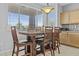 Cozy dining area with a large window providing natural light, set with table and six chairs at 7628 W Donald Dr, Peoria, AZ 85383