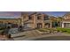 Attractive two-story home featuring a two-car garage, well-manicured front lawn, and covered porch at 7628 W Donald Dr, Peoria, AZ 85383