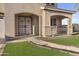 Inviting home exterior showcasing a lovely entryway with manicured artificial turf and a security door at 7628 W Donald Dr, Peoria, AZ 85383