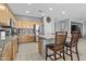 Bright kitchen featuring a central island with breakfast bar seating and stainless-steel appliances at 7628 W Donald Dr, Peoria, AZ 85383