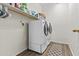Bright laundry room with modern washer and dryer, ample storage, and neutral finishes at 7628 W Donald Dr, Peoria, AZ 85383