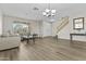 Bright, spacious living room featuring hardwood floors, ample seating, and stairway to the second floor at 7628 W Donald Dr, Peoria, AZ 85383