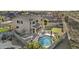 Aerial view of a backyard with a pool, hot tub, grass, and a covered patio at 7628 W Donald Dr, Peoria, AZ 85383