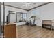 Workout room featuring wood floors, a large mirror, a ceiling fan, a treadmill and space for weights at 7628 W Donald Dr, Peoria, AZ 85383