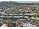 Expansive aerial view of a residential neighborhood with mountain views and lush landscaping at 7732 E Coolidge St, Scottsdale, AZ 85251