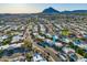 Wide angle aerial shot of a neighborhood with lush landscaping and mountain views at 7732 E Coolidge St, Scottsdale, AZ 85251