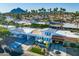 Stunning aerial view of a charming home with well-maintained landscaping, a convenient carport, and vibrant curb appeal at 7732 E Coolidge St, Scottsdale, AZ 85251