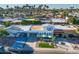 Panoramic aerial view of the home and its surrounding neighborhood with lush greenery at 7732 E Coolidge St, Scottsdale, AZ 85251