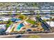 Extensive aerial view highlighting a sparkling pool, lush gardens, and well-manicured lawns within a vibrant residential area at 7732 E Coolidge St, Scottsdale, AZ 85251