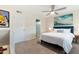 Bright bedroom featuring a plush bed, a ceiling fan, and modern artwork, creating a comfortable and stylish retreat at 7732 E Coolidge St, Scottsdale, AZ 85251