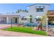 Charming home featuring a white exterior, manicured landscaping, and covered parking at 7732 E Coolidge St, Scottsdale, AZ 85251