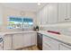 Bright kitchen featuring white cabinets, modern countertop, and stainless steel appliances at 7732 E Coolidge St, Scottsdale, AZ 85251