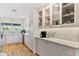 Stylish kitchen featuring custom white cabinetry with glass fronts and modern countertops at 7732 E Coolidge St, Scottsdale, AZ 85251