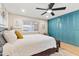 Cozy main bedroom with a ceiling fan, neutral decor, and a view to the outdoors at 7732 E Coolidge St, Scottsdale, AZ 85251