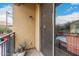 Cozy balcony with stucco wall, metal railing, aloe plant, and sliding glass door at 8105 W Groom Creek Rd, Phoenix, AZ 85043
