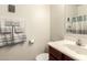 Cozy half-bath with a white sink, cherry vanity, and decorative mirror on the wall at 8105 W Groom Creek Rd, Phoenix, AZ 85043