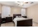 Comfortable bedroom with plush carpeting, ceiling fan, and natural light from the windows at 8105 W Groom Creek Rd, Phoenix, AZ 85043