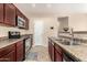 Traditional kitchen boasts granite counters, stainless appliances, and wood cabinets at 8105 W Groom Creek Rd, Phoenix, AZ 85043