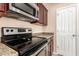 Close up of the electric stove, microwave and the granite counters in the kitchen at 8105 W Groom Creek Rd, Phoenix, AZ 85043