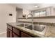 Stylish kitchen features a stainless steel sink, granite countertops, and eat in breakfast bar at 8105 W Groom Creek Rd, Phoenix, AZ 85043