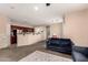 Open-concept living room with plush carpet, ceiling fan, and access to the kitchen and dining area at 8105 W Groom Creek Rd, Phoenix, AZ 85043