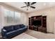 Comfortable living room with a large window, carpeted floors, and entertainment center at 8105 W Groom Creek Rd, Phoenix, AZ 85043