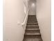 Carpeted staircase leading to the upper level with white handrail and neutral walls at 8105 W Groom Creek Rd, Phoenix, AZ 85043