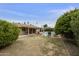 Large backyard with a pool and a spacious lawn surrounded by mature trees and landscaping at 8317 E Via De La Escuela --, Scottsdale, AZ 85258
