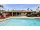 Inviting backyard featuring a pristine pool, covered patio, and ample seating at 8317 E Via De La Escuela --, Scottsdale, AZ 85258