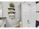 Bathroom featuring a shower, shelving with decorative plants, modern toilet, and stylish design at 8317 E Via De La Escuela --, Scottsdale, AZ 85258